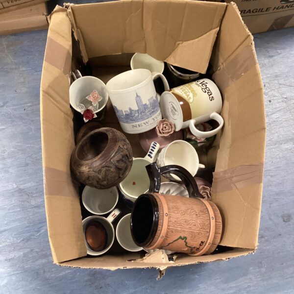 Mixed lot of collectible Starbucks mugs and coffee cups.