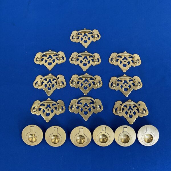 Ornate antique brass campaign chest handles for furniture restoration.