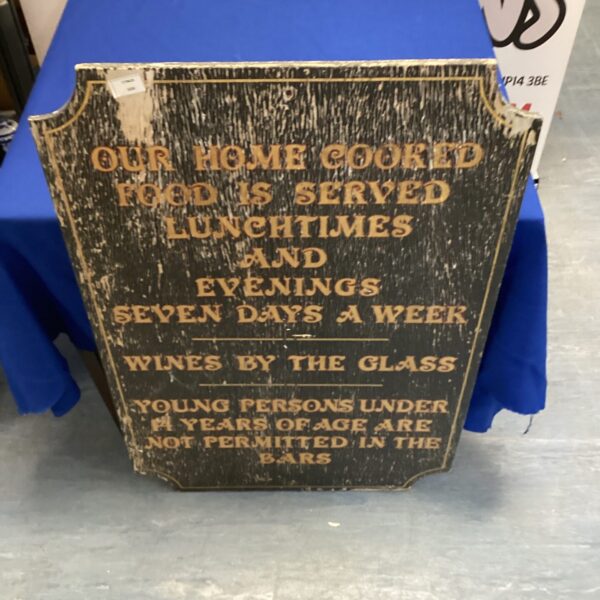 Vintage pub sign advertising food service lunchtimes and evenings.
