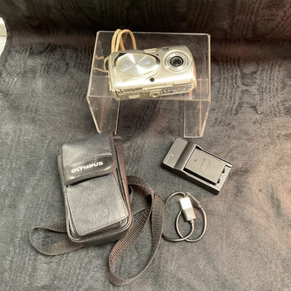 Silver Olympus Umju digital camera with case and accessories.