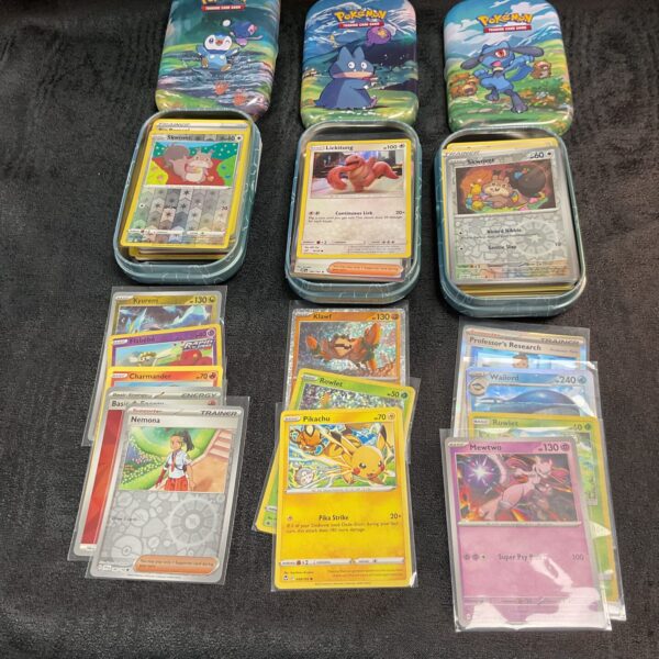 Lot of three vintage Pokemon card tins for collectors.