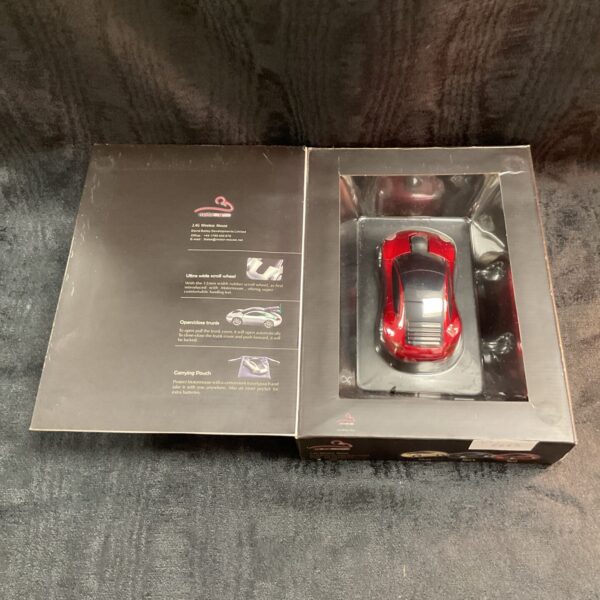 Red motor mouse car in original packaging, novelty computer accessory.
