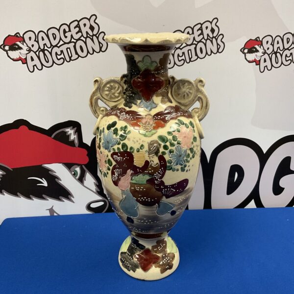Front view of a vibrant hand-painted oriental vase with floral designs.