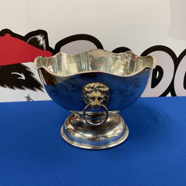 Antique silver plate bowl with ornate lion head handles.