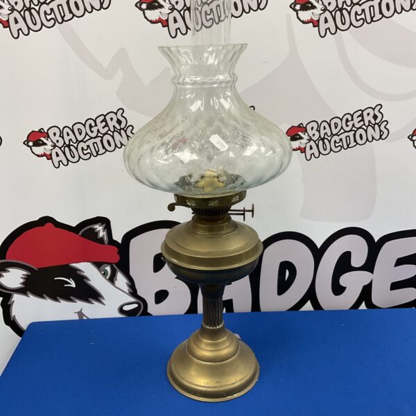 Vintage brass paraffin lamp with glass shade and chimney.