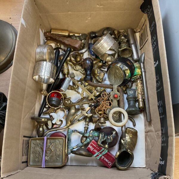 Vintage brass curios tray with cats, bottle openers, and candlesticks.
