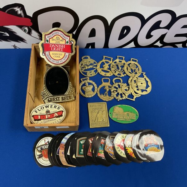 Vintage lot of horse brasses and beer pump signs for collectors.