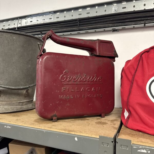 Red vintage Eversure fuel can, a collectible automotive item.
