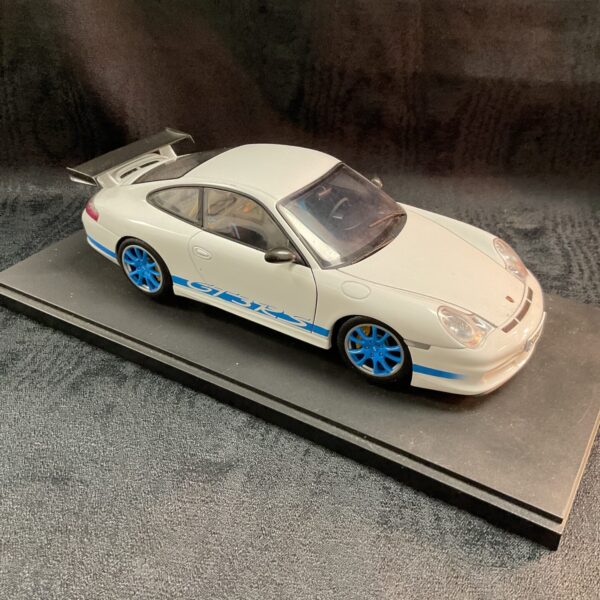 White Porsche 911 GT3RS diecast model car with blue accents.