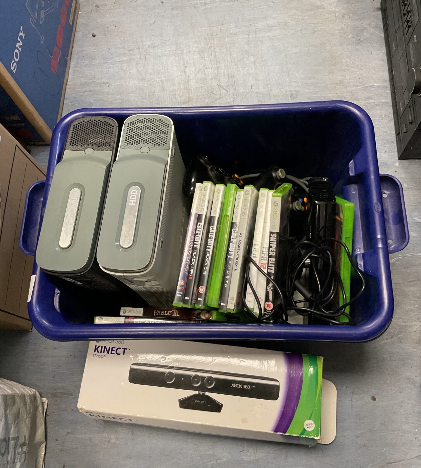 Box of microsoft xbox 360 consoles & games