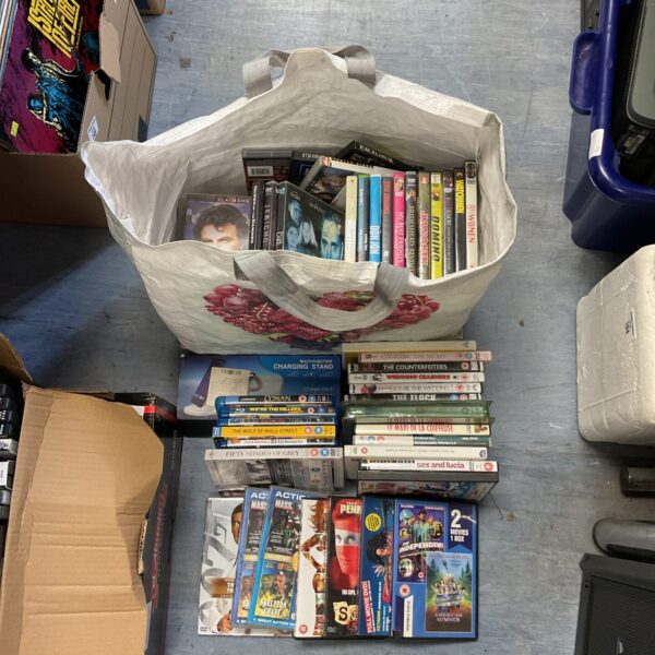 Large sack filled with assorted DVD and Blu-ray discs.