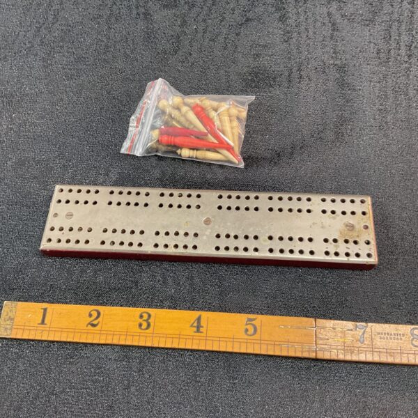 Vintage wooden Cribbage board with wooden pegs for classic gameplay.
