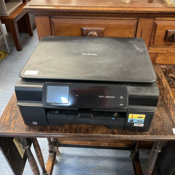 Brother DCP-J552DW colour inkjet printer on a table.