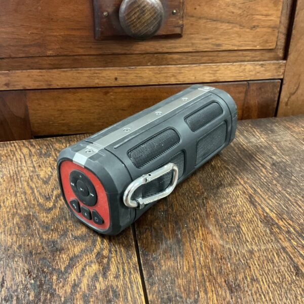 Side view of a black John Lewis Bluetooth speaker.