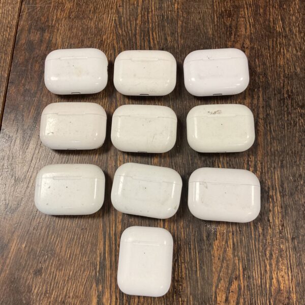 Lot of ten white Apple EarPod charging cases for wireless earbuds.