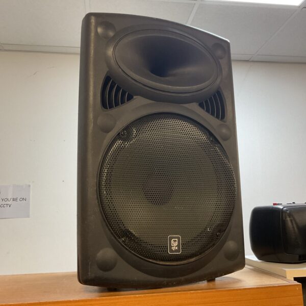Front view of a black Qtx 12 inch active PA speaker.