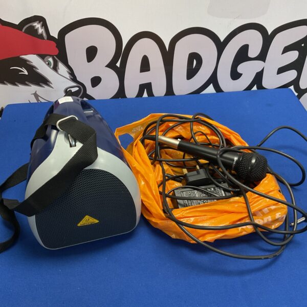 Used Behringer portable speaker system with microphone for auction.