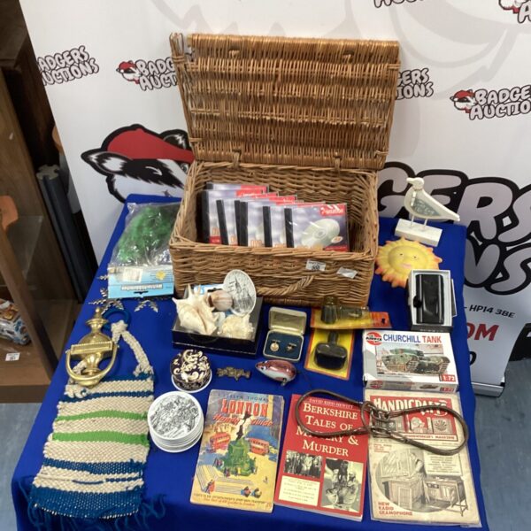 Woven basket filled with a mixed lot of vintage collectibles.