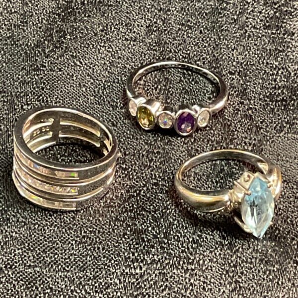 Silver CZ ring set featuring three rings with cubic zirconia stones.