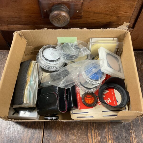 Vintage camera lenses and accessories lot for collectors.
