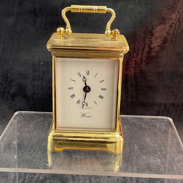 Vintage brass Weiss quartz carriage clock with Roman numerals.