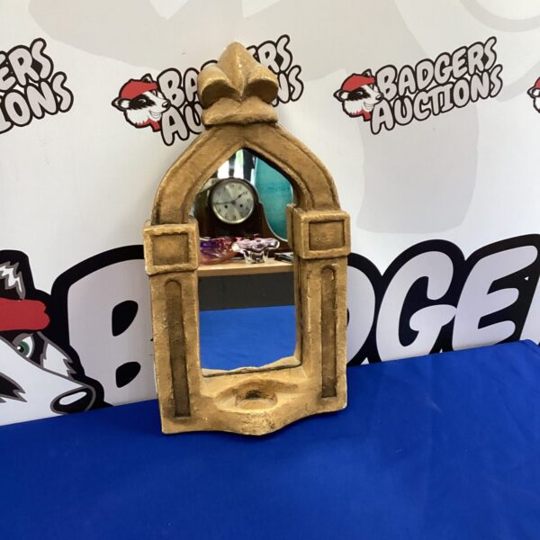 Handcrafted mirror and candle holder with vintage style.
