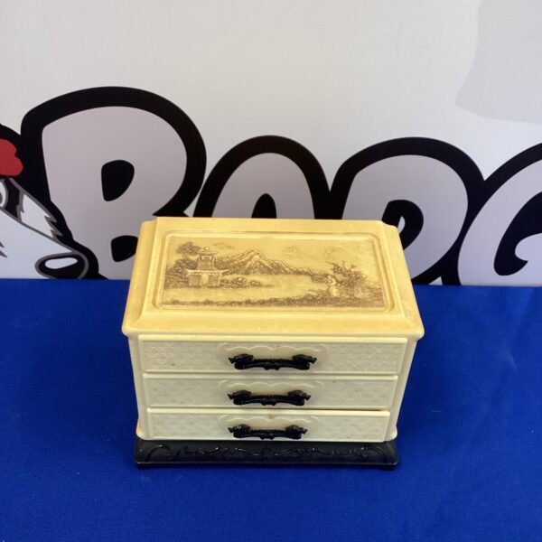 Vintage yellow celluloid jewellery box with oriental design.