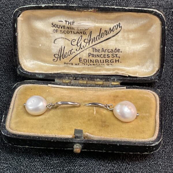 Vintage silver and pearl drop earrings displayed in a velvet box.