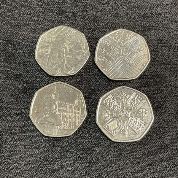 Four 50p coins including Paddington Bear and Pride designs.