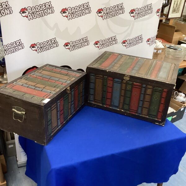 Vintage 1930s book effect storage chests on a blue surface.