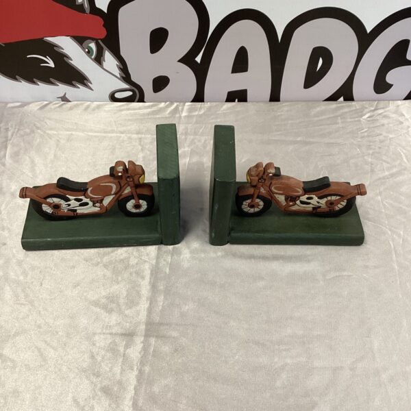 Vintage metal motorcycle bookends for desk or shelf display.