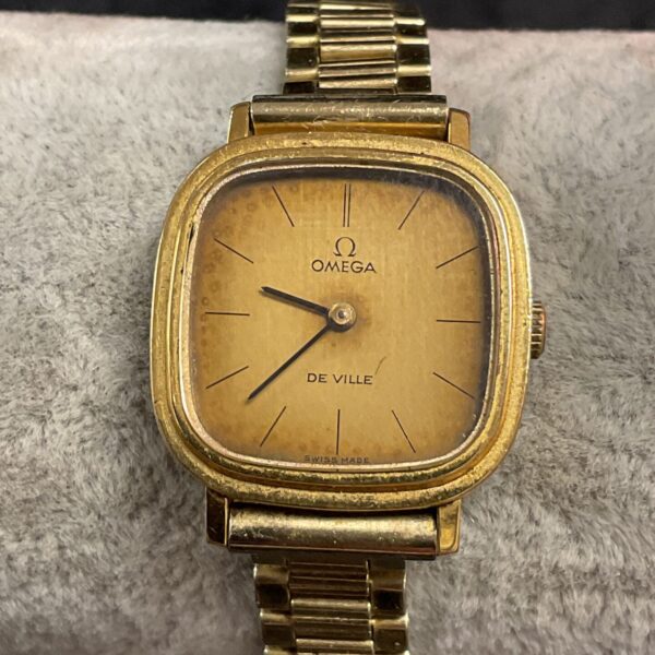 Front view of a vintage gold Omega De Ville wristwatch.