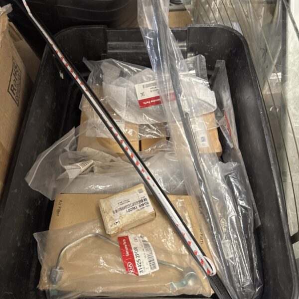 Mixed lot of automotive parts including Kia components for vehicle repair.