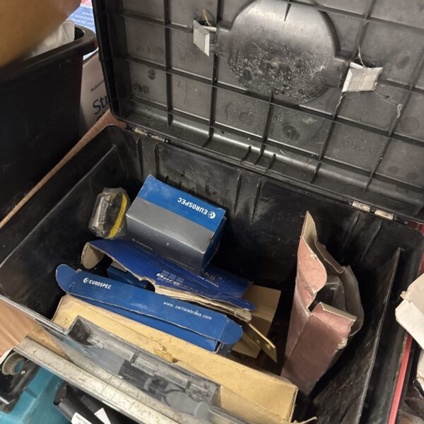 Closed plastic tool box with assorted contents inside.