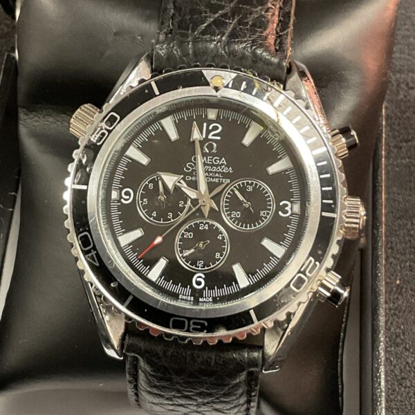 Black dial Seamaster quartz wristwatch, stylish fashion accessory.