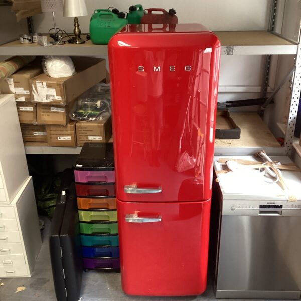 Full view of a red Smeg retro fridge freezer in a garage.