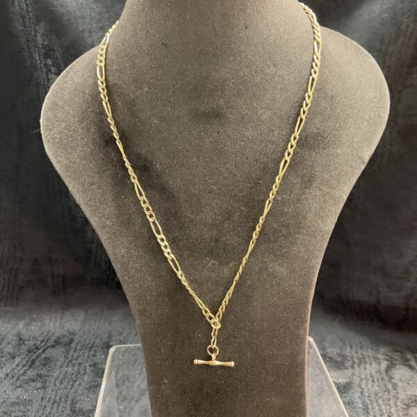 9ct yellow gold Figaro chain necklace on a display bust.