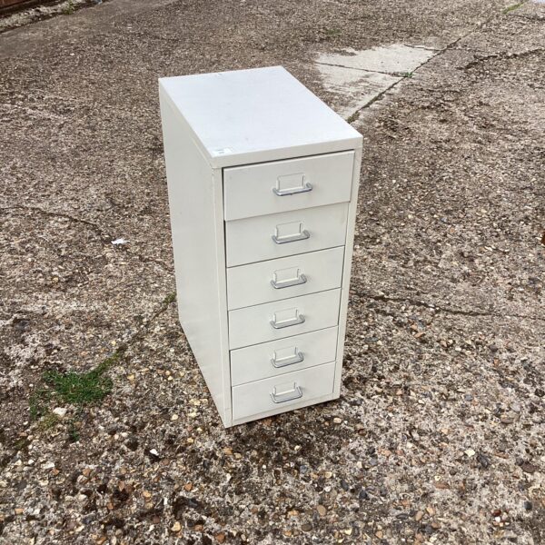 Small metal drawer unit for office or workshop storage.