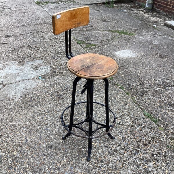 Vintage draftsmans chair with adjustable height and wooden seat.