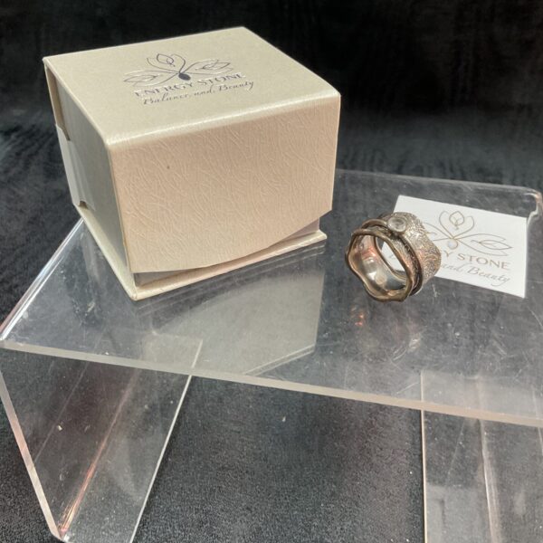 Silver spinner ring with white stone, size O.