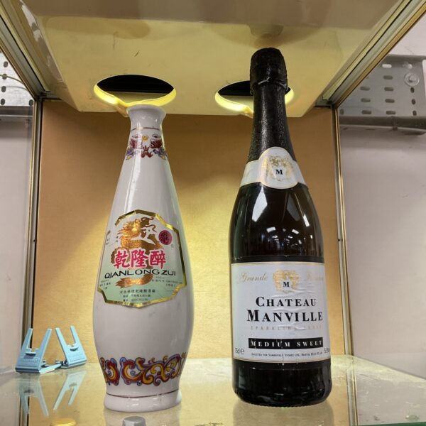 Vintage Qianlongzui sake and Chateau Manville perry bottles, sealed and collectible.