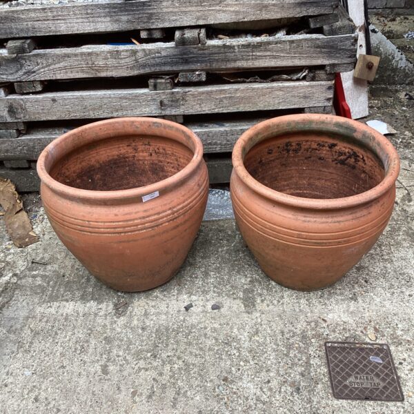 Two large terracotta plant pots for garden display.