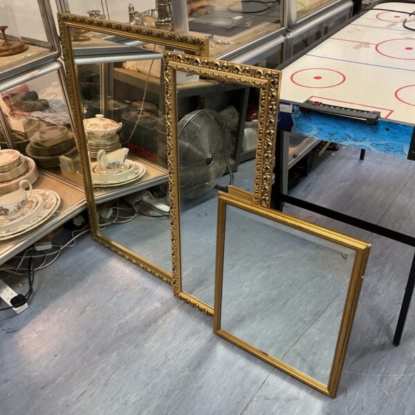 Ornate gilt French style mirror with gold frame.