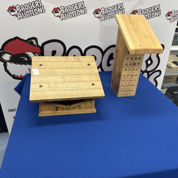 Pair of rustic wooden bird feeders for garden use.