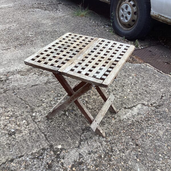 Vintage folding garden table with wooden slats and wrought iron legs.