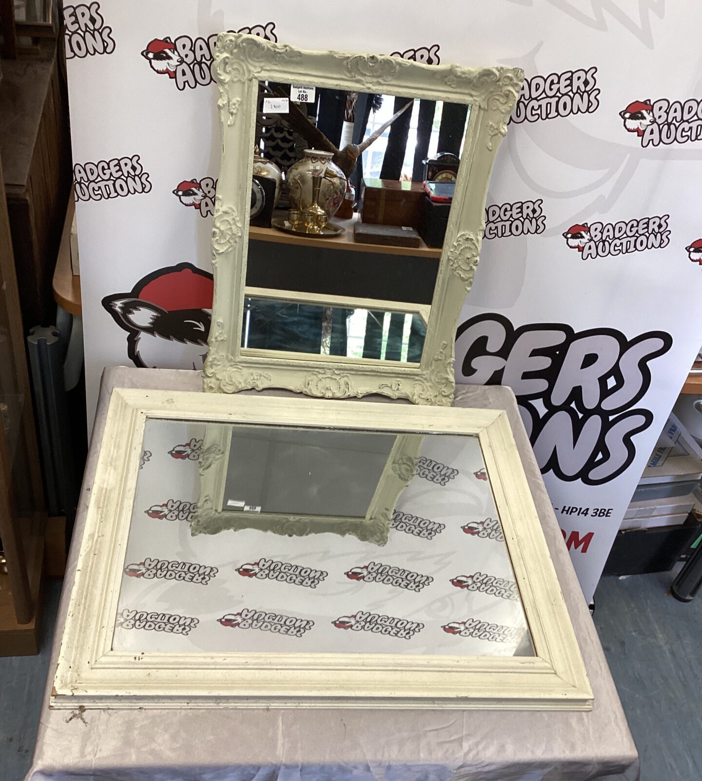 Two wooden framed wall mirrors