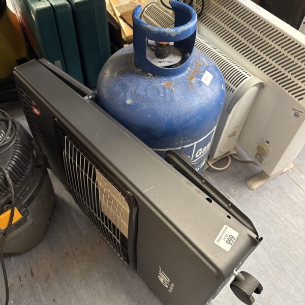 Used portable butane heater with full gas canister for outdoor use.