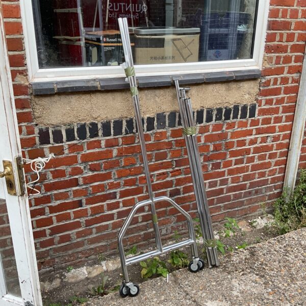 Chrome mobile clothes rail for garment display and storage.