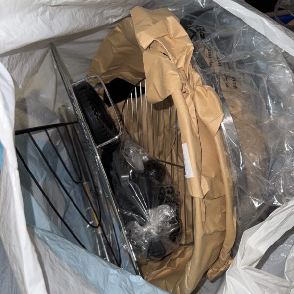 Unused stainless steel barbecue set still sealed in packaging.