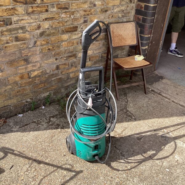 Front view of a used Bosch power washer for garden cleaning.